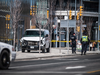Police guard a damaged van after a driver drove into Toronto pedestrians on Monday, killing at least 10.