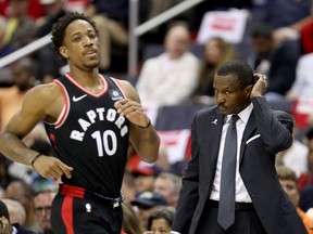 Toronto Raptors guard DeMar DeRozan runs past head coach Dwane Casey against the Washington Wizards on April 22.