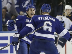 Tampa Bay Lightning center Yanni Gourde, left, celebrates his goal against the Buffalo Sabres with defenseman Anton Stralman during the first period of an NHL hockey game Friday, April 6, 2018, in Tampa, Fla.
