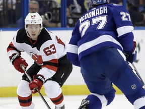 New Jersey Devils left wing Jesper Bratt (63) carries the puck at Tampa Bay Lightning defenseman Ryan McDonagh (27) during the first period of Game 5 of an NHL first-round hockey playoff series Saturday, April 21, 2018, in Tampa, Fla.