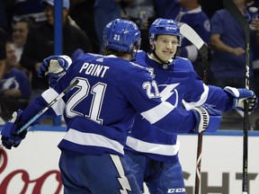 Tampa Bay Lightning center Yanni Gourde, right, celebrates his goal against the New Jersey Devils with center Brayden Point during the second period of Game 1 of an NHL first-round hockey playoff series Thursday, April 12, 2018, in Tampa, Fla.