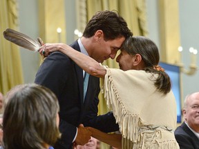 Justin Trudeau hugs Elder Evelyn Commanda-Dewache, a residential school survivor, during the closing ceremony of the Indian Residential Schools Truth and Reconciliation Commission, at Rideau Hall in Ottawa on June 3, 2015.