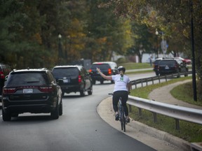 Juli Briskman directed the gesture toward a string of black SUVs that zoomed by her on her bicycle on Oct. 28, as Trump’s motorcade was leaving Trump National Golf Course in Sterling, Virginia. Reporters and photographers in a car behind her captured the moment, which quickly spread online and became a source of many jokes on late-night television.