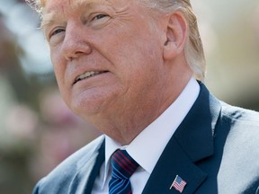 US President Donald Trump speaks about tax cuts during an event with American workers in the Rose Garden of the White House in Washington, DC. The Democratic Party filed a lawsuit on April 20, 2018 alleging that Russia, WikiLeaks and top officials from Donald Trump's campaign conspired to tilt the 2016 US presidential election in the Republican's favor.