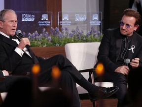 Former President George W. Bush, left, and U2 musician Bono participate in a Q&A session during a gala for the  Forum on Leadership at the George W. Bush Institute, Thursday, April 19, 2018, in Dallas.