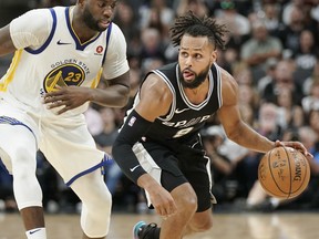 San Antonio Spurs guard Patty Mills, right, drives against Golden State Warriors forward Draymond Green during the second half of Game 4 of a first-round NBA basketball playoff series in San Antonio, Sunday, April 22, 2018, in San Antonio. San Antonio won 103-90.
