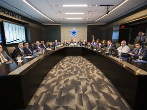 Dallas Cowboys Wwner Jerry Jones, center, coach Jason Garrett, center left, CEO and Executive Vice President Stephen Jones, center right, and other Cowboys executives wait to make their first-round pick in the NFL football draft, Thursday, April 26, 2018, in Frisco, Texas.