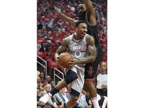 Minnesota Timberwolves guard Jeff Teague (0) looks to pass the ball around Houston Rockets guard James Harden during the first half in Game 2 of a first-round NBA basketball playoff series Wednesday, April 18, 2018, in Houston.