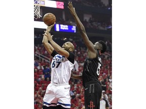 Minnesota Timberwolves forward Taj Gibson (67) shoots as Houston Rockets center Clint Capela defends during the first half in Game 5 of a first-round NBA basketball playoff series, Wednesday, April 25, 2018, in Houston.