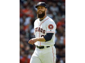 Houston Astros starting pitcher Dallas Keuchel smiles as he walks to the dugout after finishing the fifth inning of a baseball game against the Baltimore Orioles, Wednesday, April 4, 2018, in Houston.