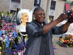 Rhea Brown Lawson, director of the Houston Public Library, takes a photo in front of a memorial for former first lady Barbara Bush, Thursday, April 19, 2018, in Houston.