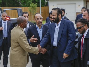 Khalid al-Falih, energy minister of Saudi Arabia, center, introduces Saudi Crown Prince Mohammed bin Salman, right, to Houston Mayor Sylvester Turner at a Habitat for Humanity home, Saturday, April 7, 2018, in Houston. The subdivision Prince Mohammed toured Saturday is made up of Habitat for Humanity homes that were flooded a year earlier. Volunteers from the U.S.-based subsidiary of Saudi Aramco, the state-owned oil company of Saudi Arabia, had helped residents in the neighborhood clean up after the storm damage.