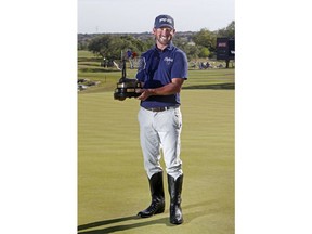 Andrew Landry holds the Texas Open trophy after winning the event with a score of 17 under par, Sunday, April 22, 2018, in San Antonio.