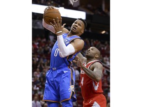 Oklahoma City Thunder guard Russell Westbrook (0) pulls down a rebound in front of Houston Rockets forward PJ Tucker (4) during the first half of an NBA basketball game Saturday, April 7, 2018, in Houston.