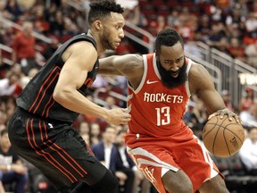 Houston Rockets guard James Harden (13) drives around Portland Trail Blazers forward Evan Turner, left, during the first half of an NBA basketball game Thursday, April 5, 2018, in Houston.