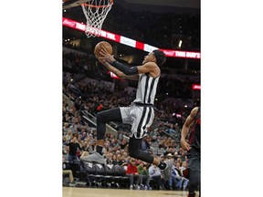 San Antonio Spurs guard Dejounte Murray goes to the basket against the Portland Trail Blazers during the first half of an NBA basketball game Saturday, April 7, 2018, in San Antonio.