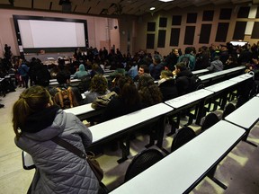 Students sit in a university classroom during their lectures. The university’s teaching staff is 11 years older on average than the labour force at large — 51 years versus 42 — and older workforces are whiter workforces.