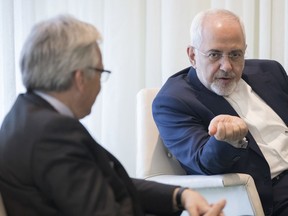 Iranian Foreign Minister Mohammad Javad Zarif, right, meets with Didier Reynders, Belgium's Deputy Prime Minister and Minister of Foreign Affairs, at United Nations headquarters, Monday, April 23, 2018.