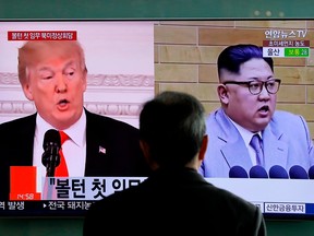 In this March 27, 2018, file photo, a man watches a TV screen showing file footages of U.S. President Donald Trump, left, and North Korean leader Kim Jong Un during a news program at the Seoul Railway Station in Seoul, South Korea.