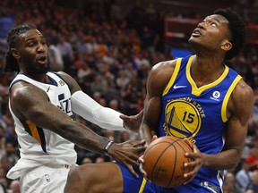 Utah Jazz forward Jae Crowder (99) fights for the ball with Golden State Warriors center Damian Jones (15) in the first half of an NBA basketball game Tuesday, April 10, 2018, in Salt Lake City.