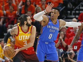 Oklahoma City Thunder guard Russell Westbrook (0) guards against Utah Jazz guard Ricky Rubio (3) in the first half during Game 3 of an NBA basketball first-round playoff series Saturday, April 21, 2018, in Salt Lake City.