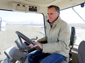 FILE - In this Feb. 16, 2018, file photo, shows former Republican presidential candidate Mitt Romney sitting behind the wheel of a tractor during a tour of Gibson's Green Acres Dairy in Ogden, Utah. Romney is gearing up for arguably the biggest challenge of his Senate campaign: A Utah Republican party convention where he'll have to face down nearly a dozen contenders in front of a far-right-leaning audience.