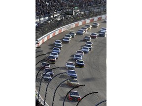 Martin Truex Jr. (78) leads the field at the start of the NASCAR Cup Series race at Richmond Raceway in Richmond, Va., Saturday, April 21, 2018.