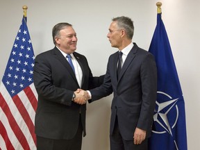 U.S. Secretary of State Mike Pompeo, left, shakes hands with NATO Secretary General Jens Stoltenberg prior to a meeting at NATO headquarters in Brussels on Friday, April 27, 2018. Mike Pompeo took over as America's top diplomat Thursday after being confirmed by the Senate and will participate in his first NATO foreign ministers meeting on Friday.