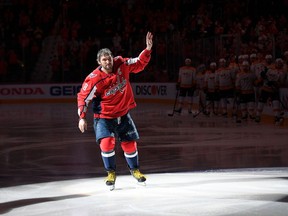 Washington Capitals left wing Alex Ovechkin, of Russia, waves to the crowd as he skates on the ice during a pre-game ceremony honoring him for his 1,000th NHL hockey game, Thursday, April 5, 2018, in Washington. His 1,000th game was last Sunday against the Pittsburgh Penguins.