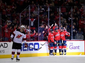 Washington Capitals left wing Alex Ovechkin (8), of Russia, celebrates his goal with Tom Wilson, right, and Michal Kempny, third from right, during the first period of an NHL hockey game as New Jersey Devils left wing Patrick Maroon, left, skates by, Saturday, April 7, 2018, in Washington.