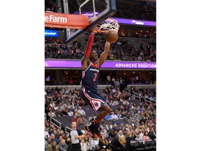 Washington Wizards guard John Wall dunks during the first half of the team's NBA basketball game against the Boston Celtics, Tuesday, April 10, 2018, in Washington.