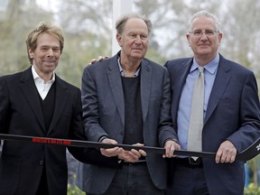 Part owners Jerry Bruckheimer, left, and David Bonderman, center, pose with Tod Leiweke and a hockey stick during a news conference naming Leiweke as the president and CEO for a prospective NHL expansion team, Wednesday, April 11, 2018, in Seattle. Leiweke is the brother of Tim Leiweke, the CEO of the group heading the redevelopment of the arena which would serve as a home for a new hockey team. The group is seeking to have a team awarded in time to begin play in 2020.