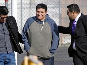 FILE - In this March 29, 2017 file photo, Daniel Ramirez Medina, center, who is a participant in the Deferred Action for Childhood Arrivals Program, walks out of the Northwest Detention Center in Tacoma, Wash., with his attorney, Luis Cortes, right, and his brother, left, who has not been identified by name, after Ramirez was released from federal custody. Court papers filed Tuesday, April 12, 2018, say that immigration officials, who under court order reinstated Ramirez's DACA status, are now trying once again to revoke it.