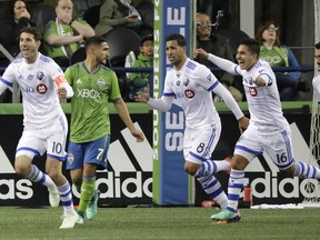 Montreal Impact forward Jeisson Vargas, second from right, celebrates with teammates after he scored a goal against the Seattle Sounders with an assist from Ignacio Piatti, left, during the second half of an MLS soccer match, Saturday, March 31, 2018, in Seattle. The Impact won 1-0.