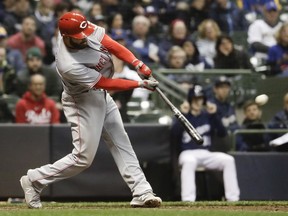 Cincinnati Reds' Jose Peraza hits a two-run scoring double during the sixth inning of a baseball game against the Milwaukee Brewers Monday, April 16, 2018, in Milwaukee.