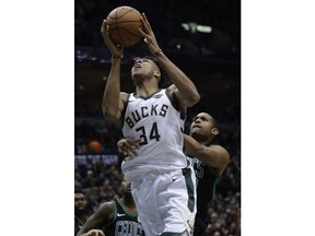 Milwaukee Bucks' Giannis Antetokounmpo is fouled by Boston Celtics' Al Horford during the first half of Game 4 of an NBA basketball first-round playoff series Sunday, April 22, 2018, in Milwaukee.