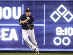 Milwaukee Brewers' Hernan Perez makes a running catch on a ball hit by Cincinnati Reds' Adam Duvall during the sixth inning of a baseball game Wednesday, April 18, 2018, in Milwaukee.