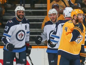 Winnipeg Jets defenceman Dustin Byfuglien (left) celebrates a goal against the Nashville Predators on April 29.