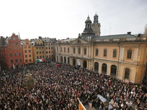 A large crowd gathers in the Stortorget square in Stockholm, while the Swedish Academy held its usual Thursday meeting at the Old Stock Exchange building seen in the background on Thursday April 19, 2018. The crowd have gathered to show their support for former Academy member and Permanent Secretary Sara Danius who stepped down last Thursday.