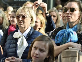 Women wear high-necked blouses with a loosely tied bow at the neck as people gathered on Stortorget square outside the headquarters of the Swedish Academy, to demand all of its remaining members resign, in Stockholm, Thursday April 19, 2018. Thousands of protesters called Thursday for the resignation of the secretive board that awards the Nobel Prize in Literature after a sex-abuse scandal linked to the prestigious Swedish academy forced the ouster of its first-ever woman head and tarnished the reputation of the coveted prize.
