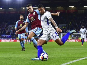 Burnley's Matthew Lowton, left, and Chelsea's Emerson Palmieri in action during the English Premier League soccer match at Turf Moor, in Burnley, England, Thursday April 19, 2018.