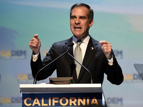 FILE - In this Saturday, Feb. 24, 2018, file photo, Los Angeles Mayor Eric Garcetti speaks at the 2018 California Democrats State Convention in San Diego. Garcetti, like other Democratic mayors considering the presidential race in 2020, is hoping to show party activists that his experience running a city can preview success on the national scene. He planned to make his debut in Iowa on April 13, talking to union carpenters, seeing representatives from the Asian, Latino and LBGTQ communities and headlining a county party dinner.