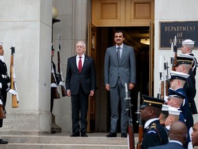 In this April 9, 2018, photo, Defense Secretary Jim Mattis stands with the Emir of Qatar Sheikh Tamim bin Hamad al-Thani during an arrival ceremony at the Pentagon. President Donald Trump is set to meet with the Emir on Tuesday.