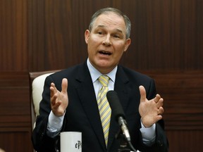 FILE - In this June 13, 2013 file photo, then-Oklahoma Attorney General Scott Pruitt gestures as he answers a question during a news conference in Oklahoma City. Newly obtained records show Pruitt's penchant for travel and concerns about security was notable even before he became head of the Environmental Protection Agency. The records show that as Oklahoma's attorney general, Pruitt frequently traveled out-of-state for appearances before conservative groups and used an office investigator as a driver.