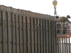 In this June 13, 2006, file photo, Utah National Guard soldiers work on extending a border fence in San Luis, Ariz., President Donald Trump said April 3, 2018, he wants to use the military to secure the U.S.-Mexico border until his promised border wall is built. The Department of Homeland Security and White House did not immediately respond to requests for comment. At the Pentagon, officials were struggling to answer questions about the plan, including rudimentary details on whether it would involve National Guard members, as similar programs in the past have done. But officials appeared to be considering a model similar to a 2006 operation in which former President George W. Bush deployed National Guard troops to the southern border in an effort to increase security and surveillance.