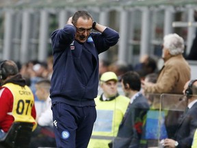 Napoli coach Maurizio Sarri reacts after his players missed a scoring chance during the Serie A soccer match between AC Milan and Napoli at the San Siro stadium in Milan, Italy, Sunday, April 15, 2018.