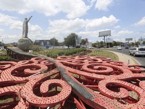 One of many metallic tree sculptures built by the government, lays charred on the ground after protesters tore it down as a symbol of the regime of President Daniel Ortega and his wife, Vice President Rosario Murillo, In Managua, Nicaragua, Tuesday, April 24, 2018. The sculptures where torn down during several days of violent demonstrations set off by a social security overhaul that left dozens dead.