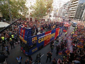 Barcelona players on a bus celebrate during a street parade in Barcelona, Spain, Monday April 30, 2018, after winning the Spanish La Liga soccer title. Barcelona clinched the 2017/18 Spanish soccer league title after a 4-2 win at Deportivo La Coruna on Sunday.