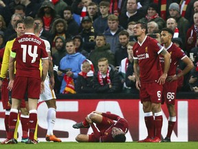 Liverpool's Alex Oxlade-Chamberlain grimaces on the ground after getting injured during the Champions League semifinal, first leg, soccer match between Liverpool and AS Roma at Anfield Stadium, Liverpool, England, Tuesday, April 24, 2018.