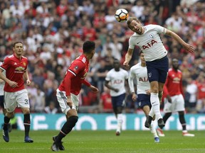 Tottenham's Harry Kane heads the ball during the English FA Cup semifinal soccer match between Manchester United and Tottenham Hotspur at Wembley stadium in London, Saturday, April 21, 2018.